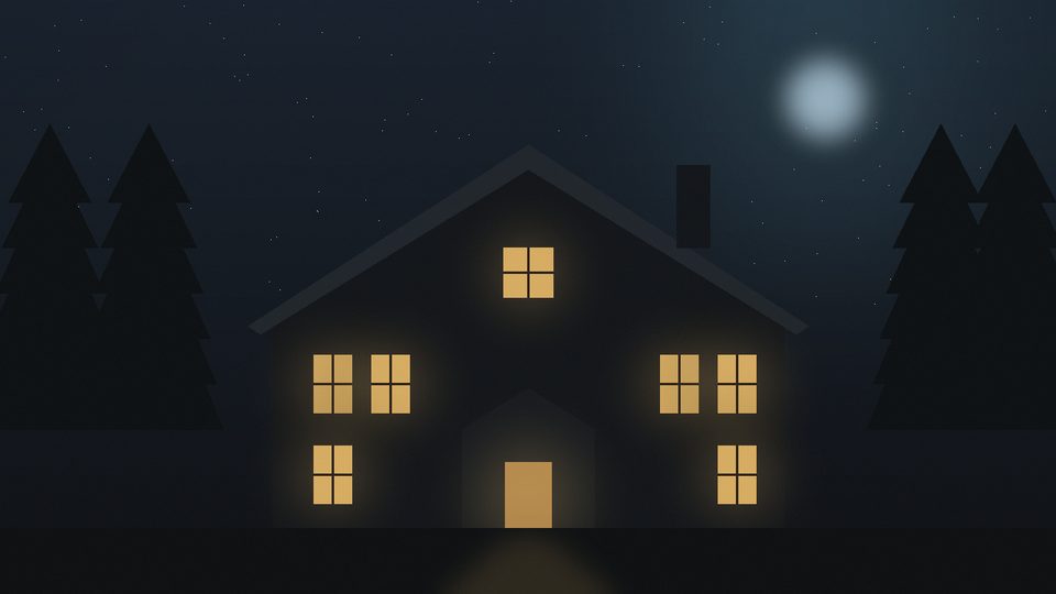 Old gabled house at night with warm light in every window