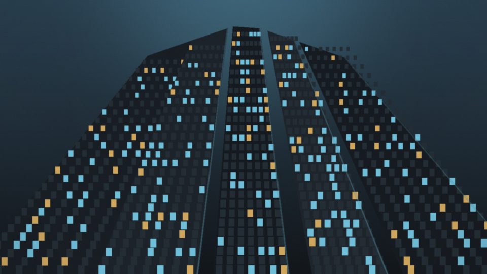 Glass towers seen from street level at dusk with lit office windows